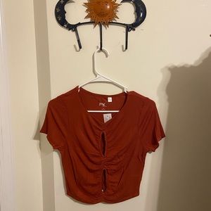 rust color pacsun crop top with cheeky cut outs!